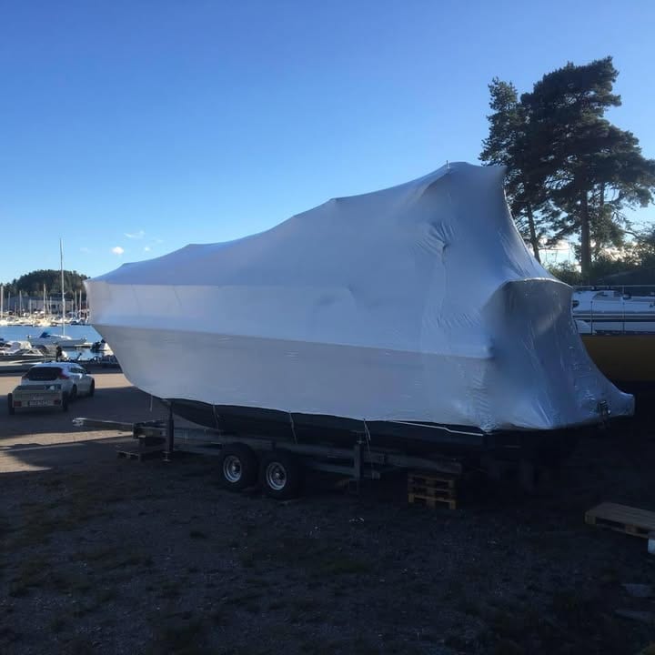 Krympplastad motorbåt vid marina på västkusten